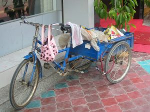 three-wheeled bicycle in China piled with junk