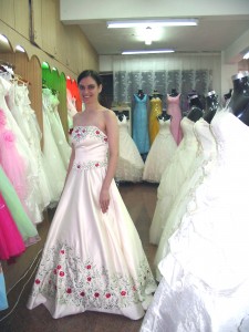 Trying on a wedding gown in on Suzhou's wedding gown street